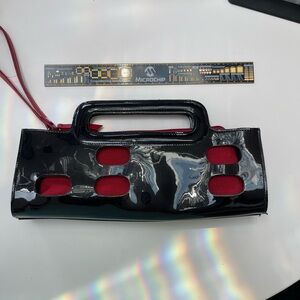 Aldo Vintage Style Clutch Purse. Black patent leather cutout. Red insert.